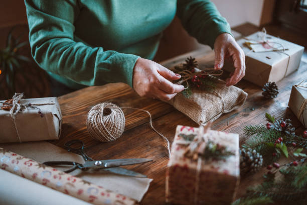istock Woman decorating Christmas gifts. 1281725551