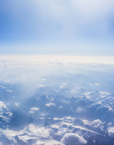 Aerial view Alpine  mountains and clouds.  View from airplane window