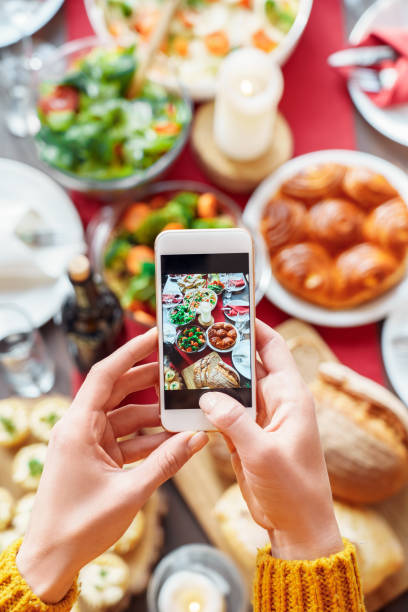 istock Woman making photo with served dinner table on smartphone 1281725812