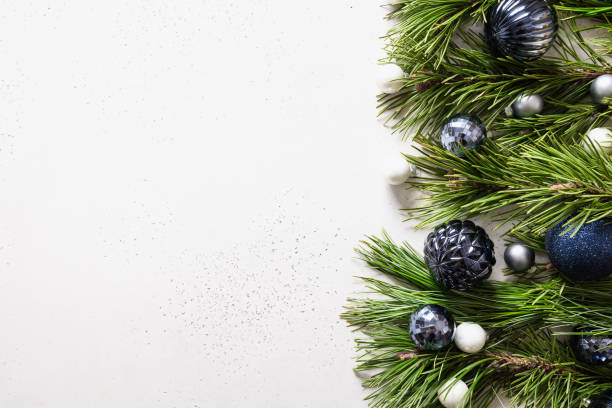 istock Christmas border with blue balls, evergreen branches on white. Xmas greeting card. 1281726871
