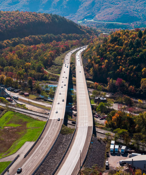 aerial view of the high bridge over the lehigh river at the pennsylvania turnpike lying between mountains in appalachian on a sunny day in fall. high resolution stitched vertical panorama. - rapid appalachian mountains autumn water imagens e fotografias de stock