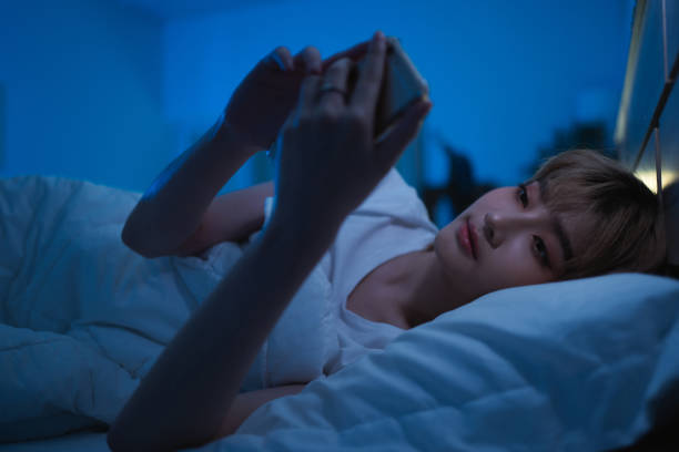 istock Asian woman using the phone social network at night she is in bed. 1281730949