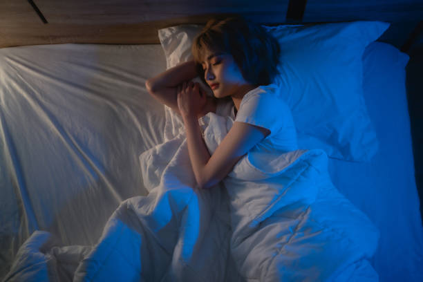 istock Asian woman sleeping in bed at night 1281730954