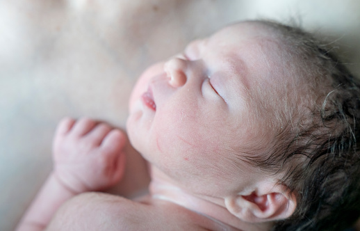 Newborn baby girl and mother in the hospital.