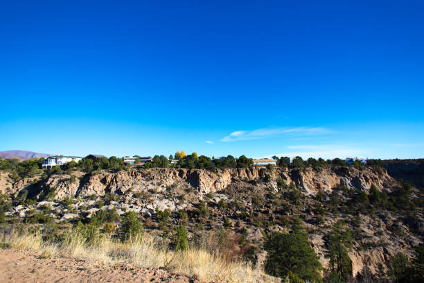 istock Los Alamos, NM: Sunlit Rocky Cliff/Mesa/Canyon with Homes on Top 1281735221