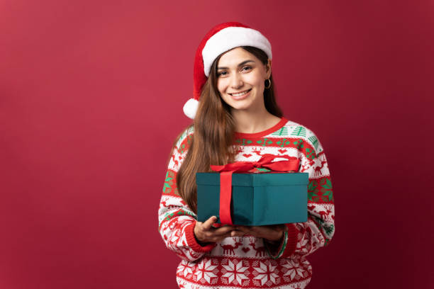 istock Pretty woman with a Christmas gift 1281739235