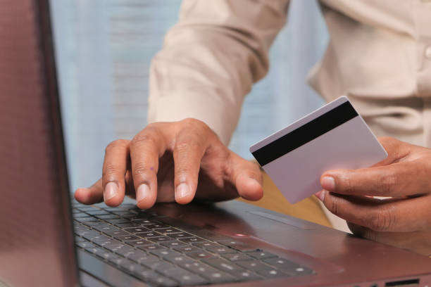 istock man hands holding credit card and using laptop shopping online 1281739372