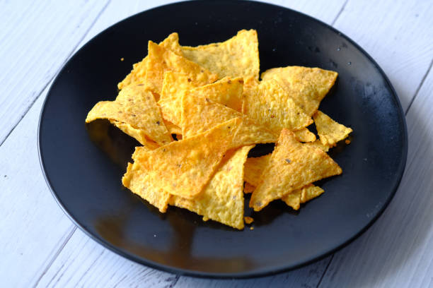 istock Bowl with tasty potato chips on wooden background . 1281740996