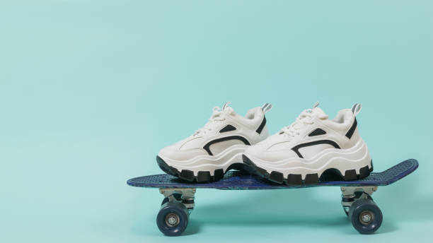 istock A pair of high-soled sneakers on a blue skateboard. 1281741160