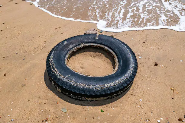 Photo of Black tires on the beach