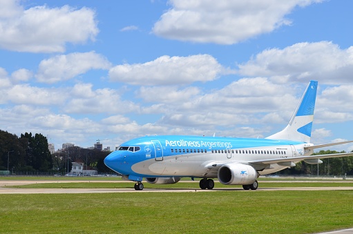 Buenos Aires, Argentina. December 31, 2016: a Boeing 737-700 from Aerolineas Argentinas holding position, just after landing, in Buenos Aires' Aeroparque Jorge Newbery. Front spot of the aircraft.