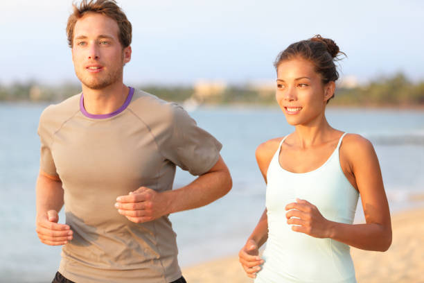 istock Running jogging couple training on summer beach 1281744050