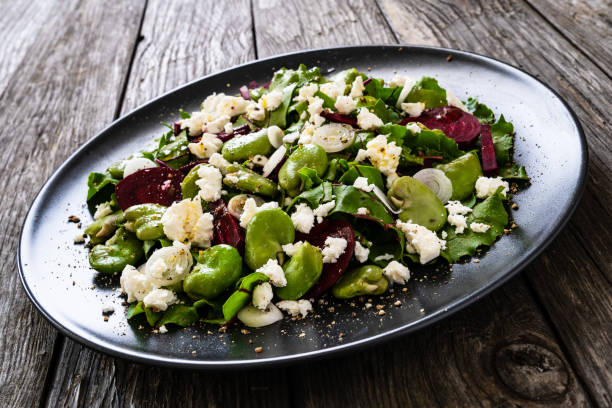 istock Beetroot salad with broad bean and goat cheese on wooden background 1281748261