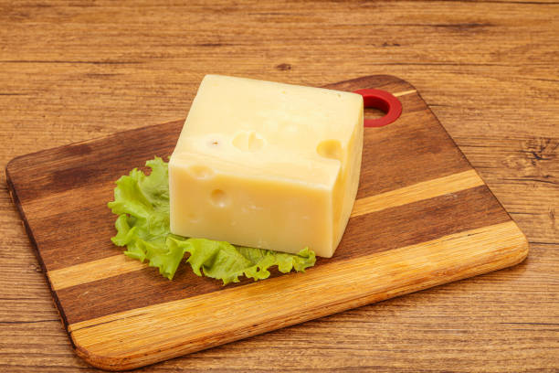 istock Emmental cheese over wooden board 1281751792