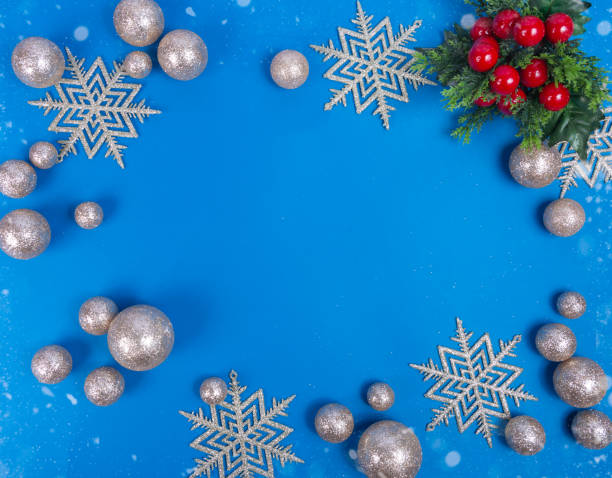 istock shiny silver balls and snowflakes on a blue background. christmas background 1281754626
