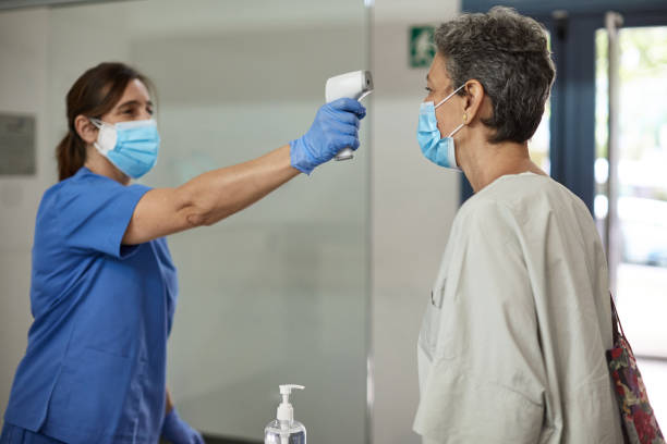 istock Medical Staff Checking Temperature with Infrared Thermometer 1281754710