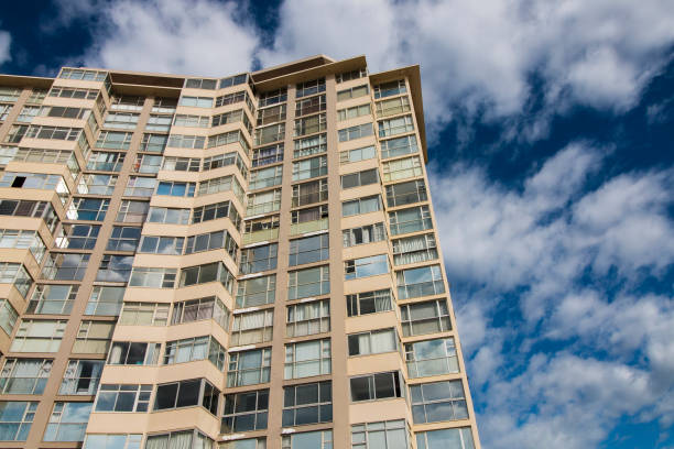 istock Tall Imposing Building Against Cloudy Blue Sky 1281757333