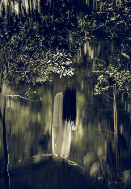 A creepy long black hair Japanese ghost woman in a dark forest.