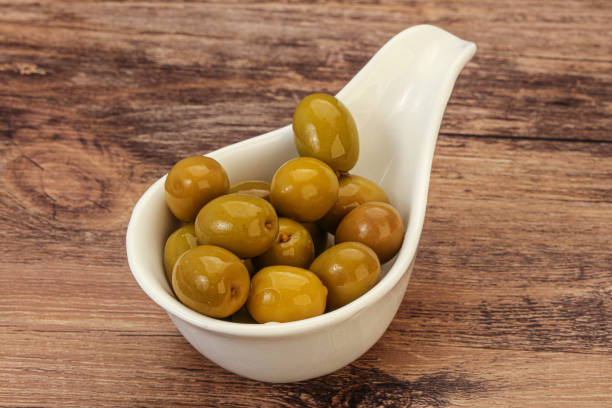 istock Green pickled olives in the bowl 1281760356
