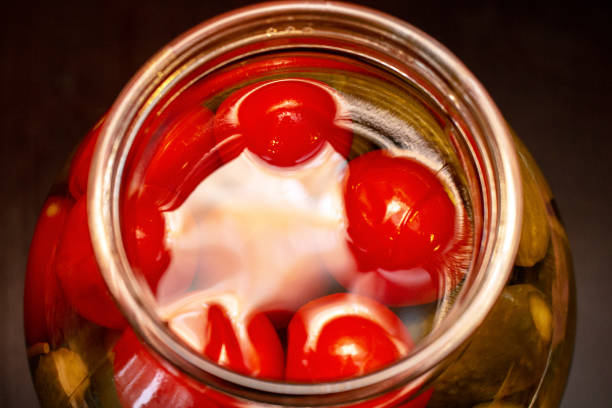 istock pickled cucumbers and tomatoes in a glass jar 1281761873