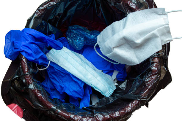 istock thrown out, discarded medical gloves and protective masks in the trash bin after quarantine 1281763736