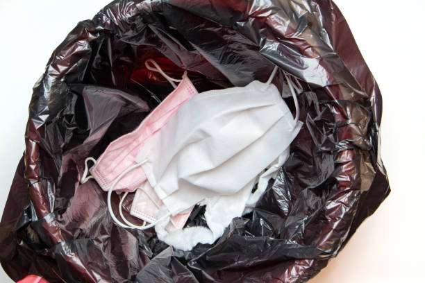 istock thrown out, discarded medical gloves and protective masks in the trash bin after quarantine 1281763754