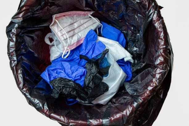 istock thrown out, discarded medical gloves and protective masks in the trash bin after quarantine 1281763762