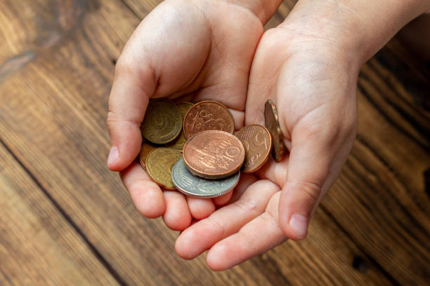 istock Two hands holding coins in the palms. 1281763791