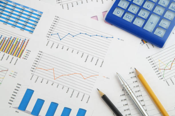 istock Calculator, pen and pencils on financial charts and graphs 1281764040