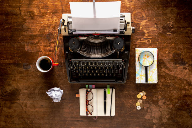 Travelling tools. Retro typewriter travel items on a old wooden desk
