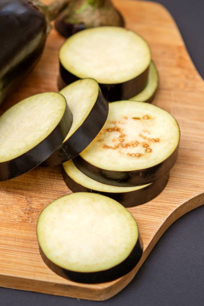 istock Eggplant on wooden cutting board 1281764178