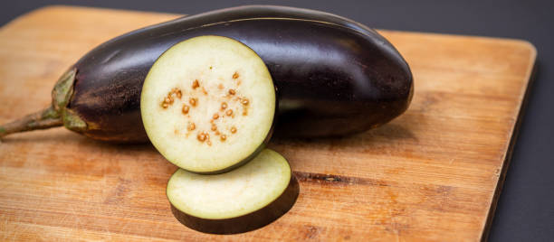 istock Eggplant on wooden cutting board 1281764199