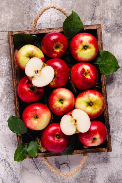 istock Ripe red apples in wooden box. 1281764319