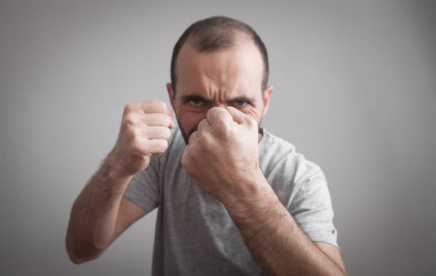 istock Caucasian angry and aggressive man threatening with fists. 1281766422