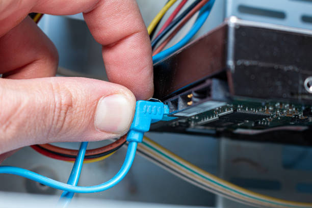 istock Connecting hdd drive disk sata cable with hand in the service. Maintenance, upgrade, installation. 1281768673