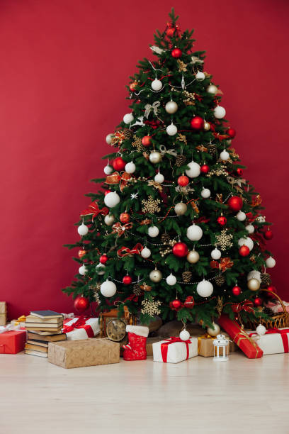 istock Christmas tree pine decor red background New Year holiday gifts 1281772029