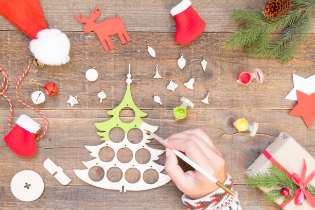 istock How to make a Christmas tree from a wooden blank. Children art project. DIY concept. Step by step photo instruction. Step 2 paint the Christmas tree 1281772241