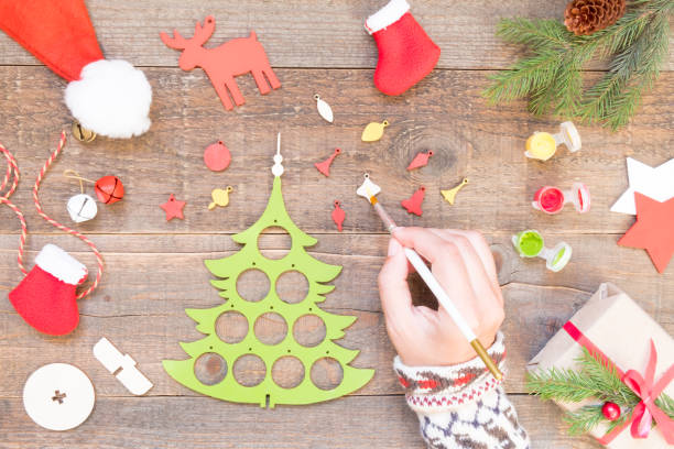istock How to make a Christmas tree from a wooden blank. DIY concept. Step by step photo. Step 3 paint Christmas tree decorations in different colors 1281772244