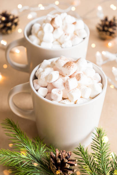 istock Two cups of hot cocoa with marshmallows on brown background 1281772289