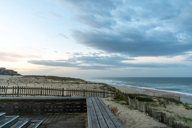 istock sand dunes and waves breaking on an endless beach under a stormy sky 1281773171