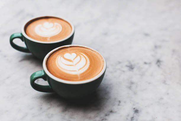 istock Two beautiful cups of cappuccino on the table. 1281773891