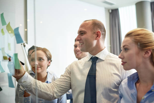 istock smiling business people with marker and stickers 1281777332