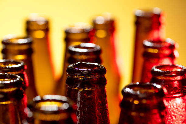 istock Neon colored beer bottles. Close up on bright studio background 1281778477