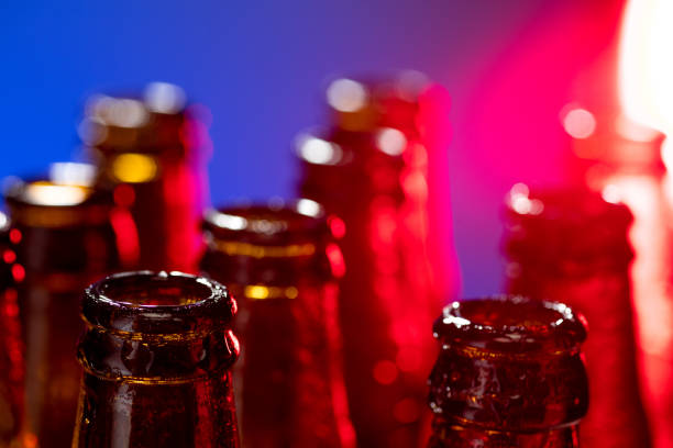 istock Neon colored beer bottles. Close up on bright studio background 1281778493
