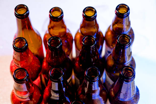 istock Neon colored beer bottles. Close up on bright studio background 1281778506