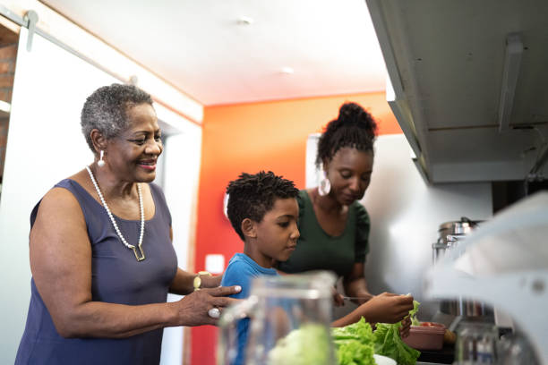 istock Three generation family washing vegetables in the kitchen at home 1281779762