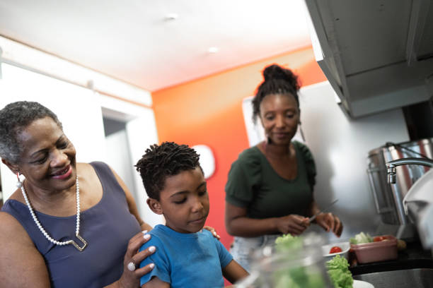 istock Three generation family washing vegetables in the kitchen at home 1281779767