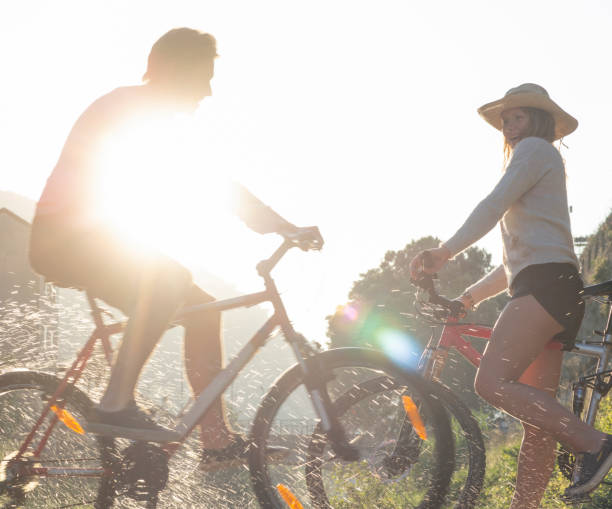 istock Two young adults meet with bicycles in the morning sunlight 1281781710