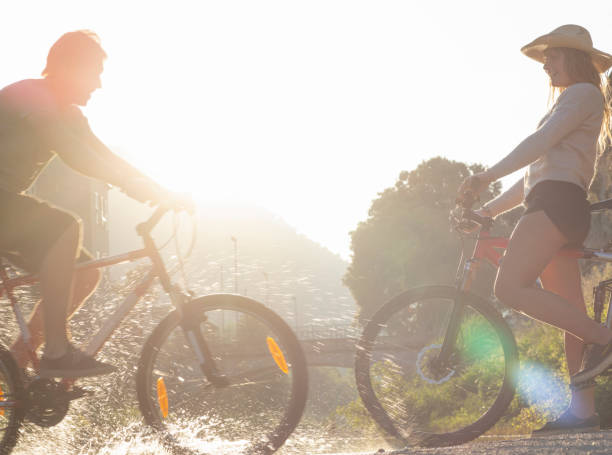 istock Two young adults meet with bicycles in the morning sunlight 1281781732