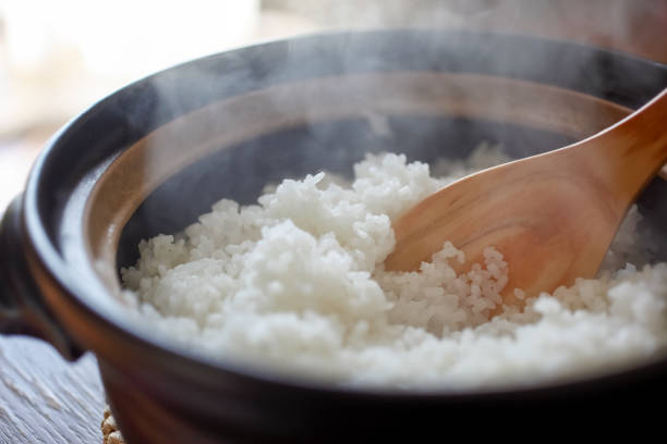 Earthenware pot rice. Hot cooked rice with steam rising. rice food staple stock pictures, royalty-free photos & images